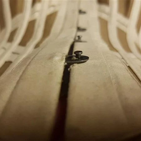 Studying corsets that have been preserved in the extensive archive of the Symington Corsetry Collection uncovered some examples of stitching where speed was prioritised over what we would now consider a more secure sewing technique. 
 
This sateen health corset of 1900 was constructed with a split steel busk, and we would usually reinforce the stitches between the busk loops by starting and stopping the seam between each individual loop, back stitching at both ends. However, this part of the corset has been manufactured with a complete seam between the busk placket and outer corset at the centre front, with stitches cut to create the gaps for the busk loops to pass through - with no sign of any reinforcement! This is certainly a much faster way of completing this step, however, in a high-stress area like a corset closure, it could create points of weakness. 
 
Mentor Constance put this technique to the test in a sample and found that our modern cotton sateens aren’t sturdy enough to make this a successful method. However, the examples we see from the period have extremely small machine stitches, which help prevent unravelling of the seam. So, while this busk insertion technique isn’t as effective with today's materials, to add a touch of authenticity to your corset, shorten your stitches! 

We explore how the spectacular Victorian corsets from the Symington archive are constructed in this month’s workshop, plus how to recreate the techniques at home – and we’ll be back for part 2 in July with our Mentors, Constance and Lowana. To watch, become a member at the link in the bio – membership now starts at £20 per month. 

Images: @vanyanis at the Symington Collection
.
.
.
#sewing #corset #corsetry #fashionhistory #costumehistory #historicalunderpinnings #learntosew #sewingtutorial #sew